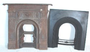 A Victorian 19th century cast iron fireplace. Cast with central recessed arch with decorative