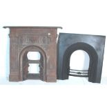 A Victorian 19th century cast iron fireplace. Cast with central recessed arch with decorative