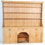 A large 19th Century Victorian large country pine Welsh dresser. The upright gallery top having
