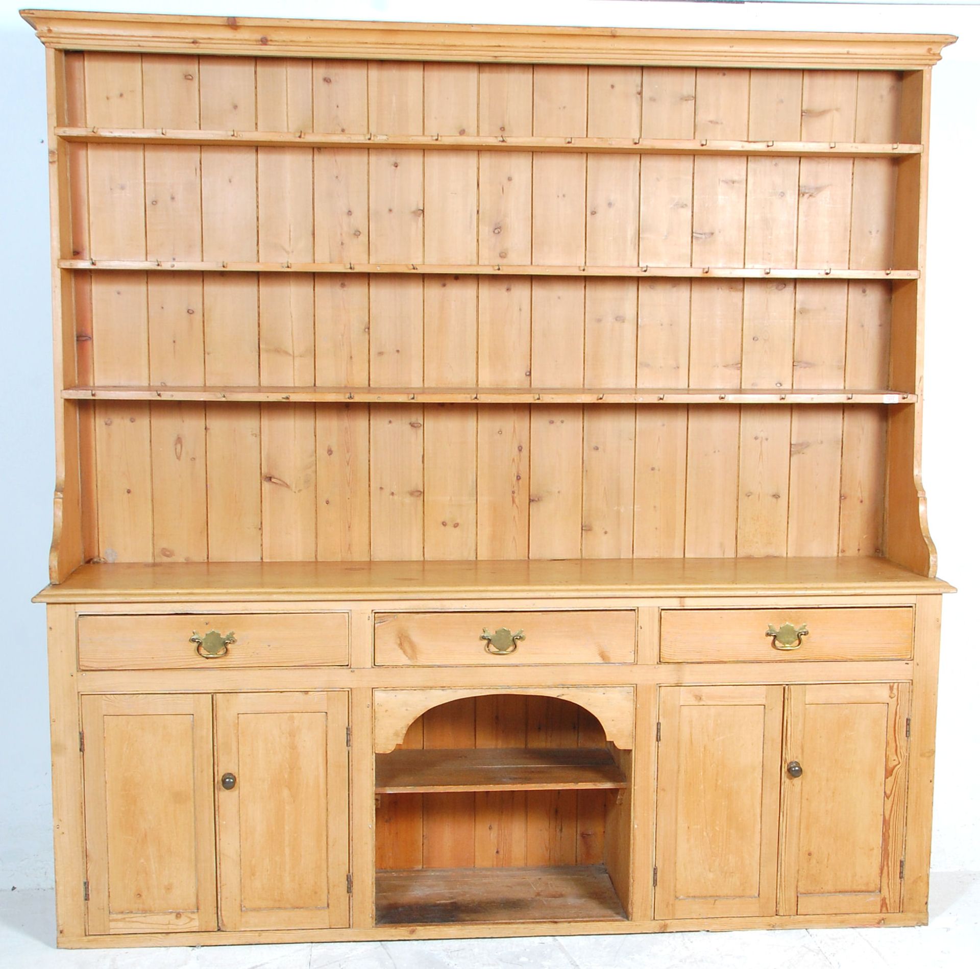 A large 19th Century Victorian large country pine Welsh dresser. The upright gallery top having