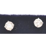 A pair of 14ct white gold diamond stud earrings, prong set with two brilliant cut diamonds.