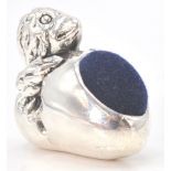 A stamped sterling silver pincushion in the form of a newly hatched chick with velvet cushion to the