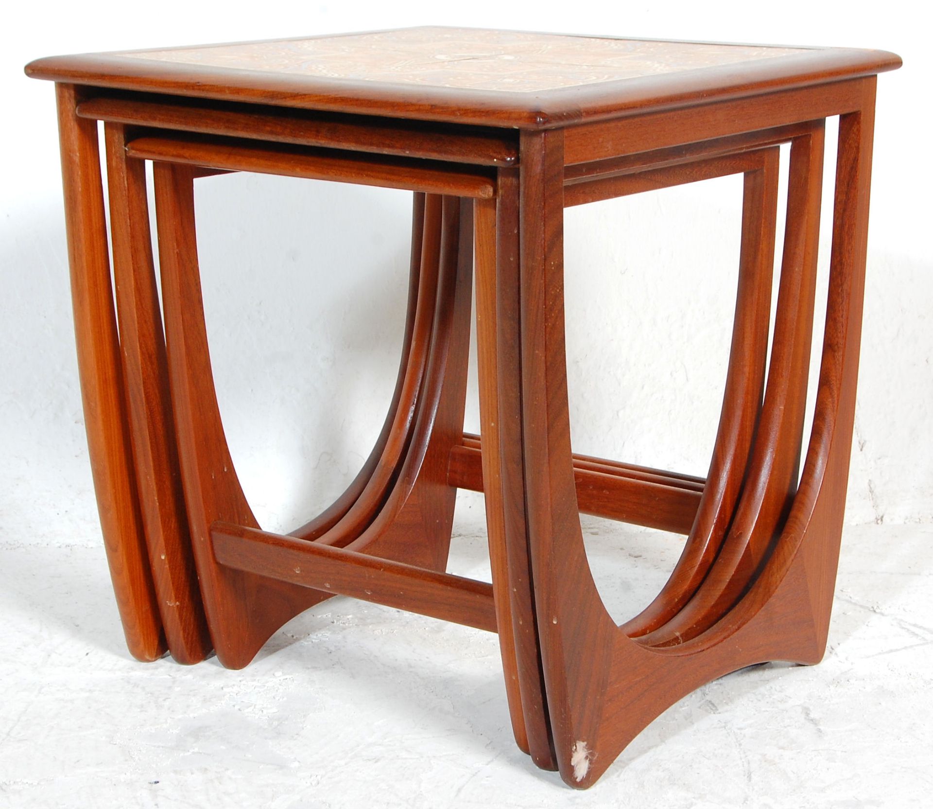 A 1970's G-Plan ' Astro ' teak wood nest of tables. The tables of graduating form with each being