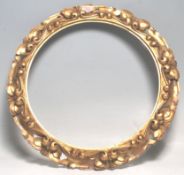 A 20th Century antique style wall hanging gilt frame having moulded scrolled decoration with foliate