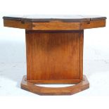A 20th Century vintage unusual scratch built octagonal games table having a columnal support on a