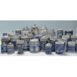 A large collection of German blue and grey stoneware jugs and beer steins, some having pewter