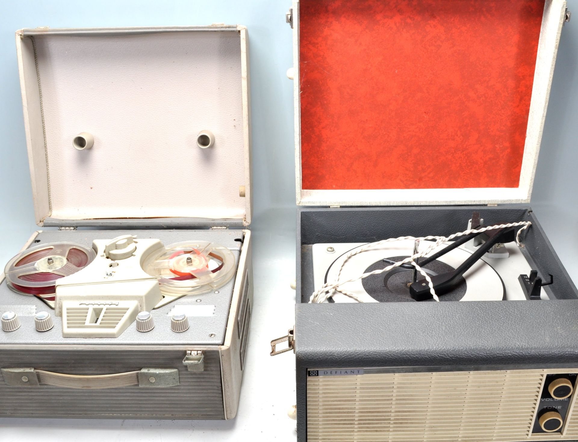 A vintage two tone Defiant portable record player together with a Philips portable reel to reel