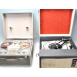 A vintage two tone Defiant portable record player together with a Philips portable reel to reel