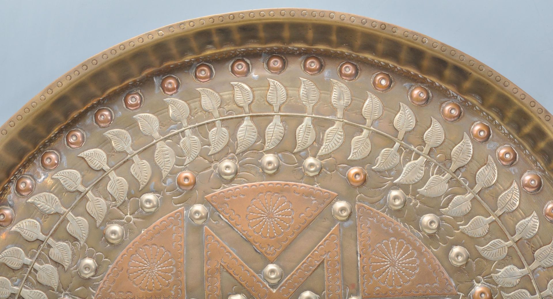 A 20th Century Middle Eastern brass and copper wall charger of circular form having inlaid white - Bild 2 aus 8