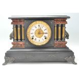 A Victorian style faux red marble and slate 24hr mantel clock featuring having a round brass white