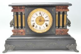 A Victorian style faux red marble and slate 24hr mantel clock featuring having a round brass white