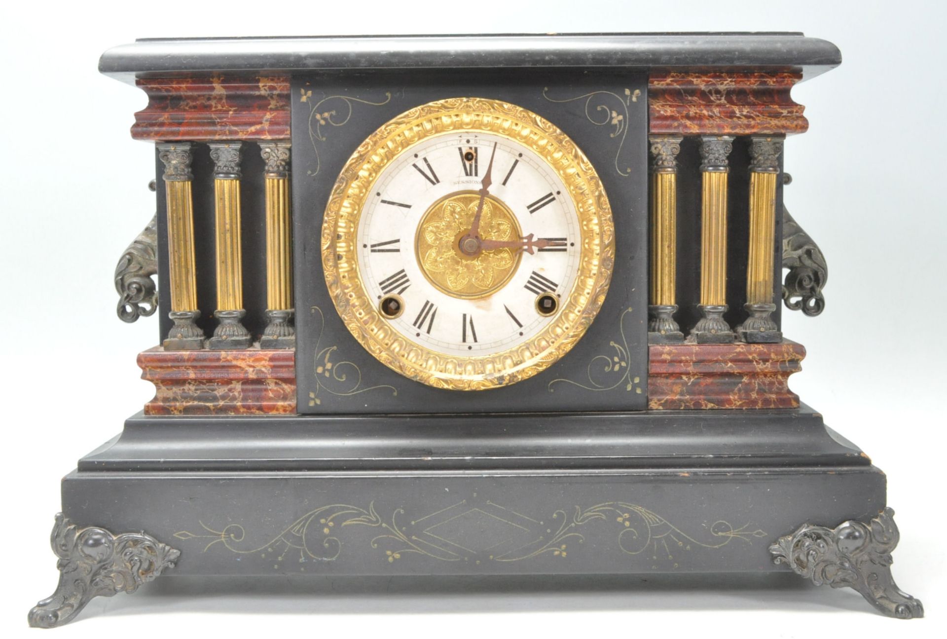 A Victorian style faux red marble and slate 24hr mantel clock featuring having a round brass white