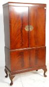 An early 20th Century Queen Anne style flame mahogany drinks / cocktail cabinet of two tiered