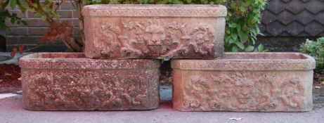 A group of three antique reconstituted stone planters of rectangular form having raised floral