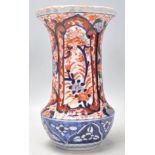 An early 20th Century Japanese Imari vase. Hand decorated cartouche panels with floral sprays having