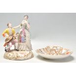 A 20th Century German Meissen / Dresden group figurine in the form of a couple with a seated man