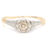 A vintage single stone old cut diamond ring with a bezel setting upon a decorative shoulder.Size 6.