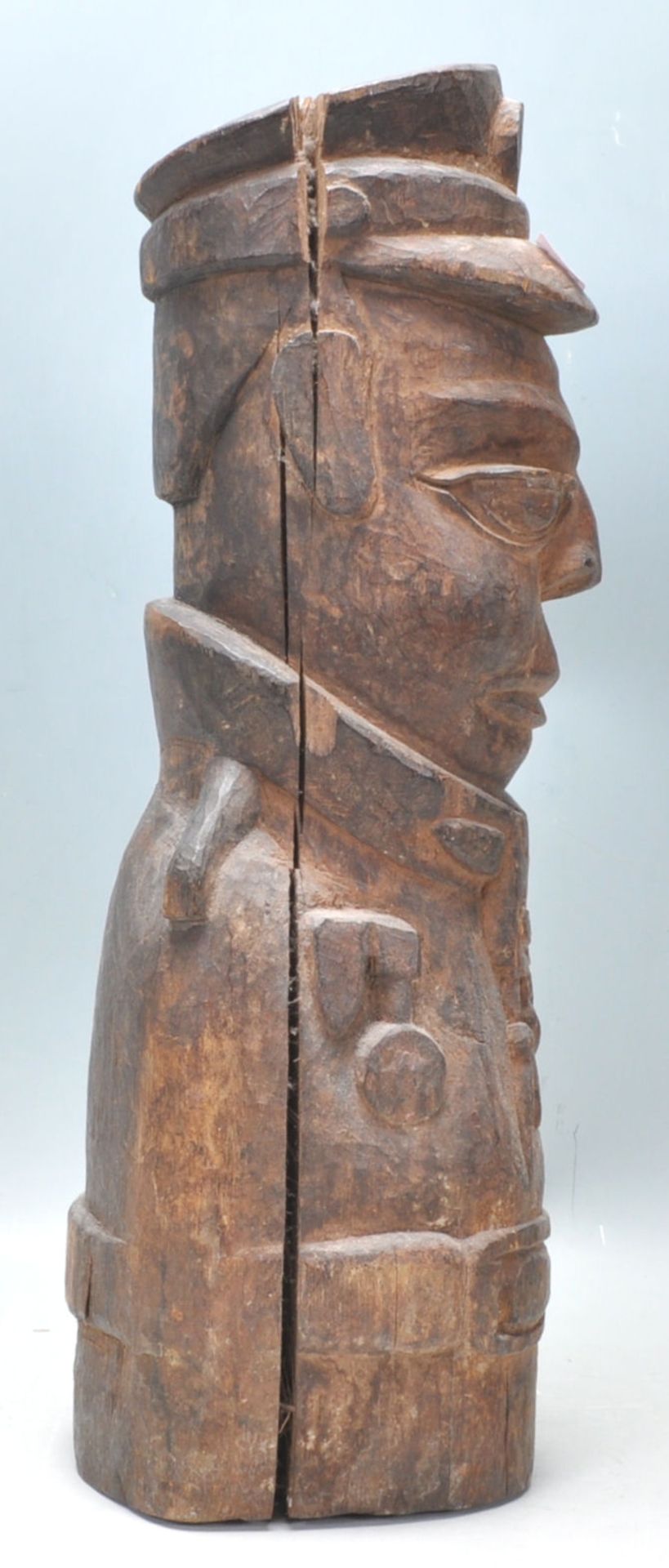 An unusual carved wooden African tribal figurine in the form of a uniformed officer, with cap to the - Bild 2 aus 5