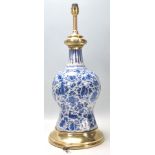 Abn 18th Century Delft blue and white ceramic lamp of waisted form having hand painted floral and
