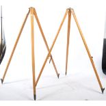 A good mid century pair of  retro wooden and cast metal surveyors tripod stands.The tapering wooden