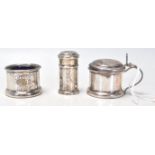 A set of three silver hallmarked table cruets to include a pepperette, table salt and lidded jam