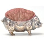 An early 20th Century English silver hallmarked pin cushion in the form of a pot belly pig having