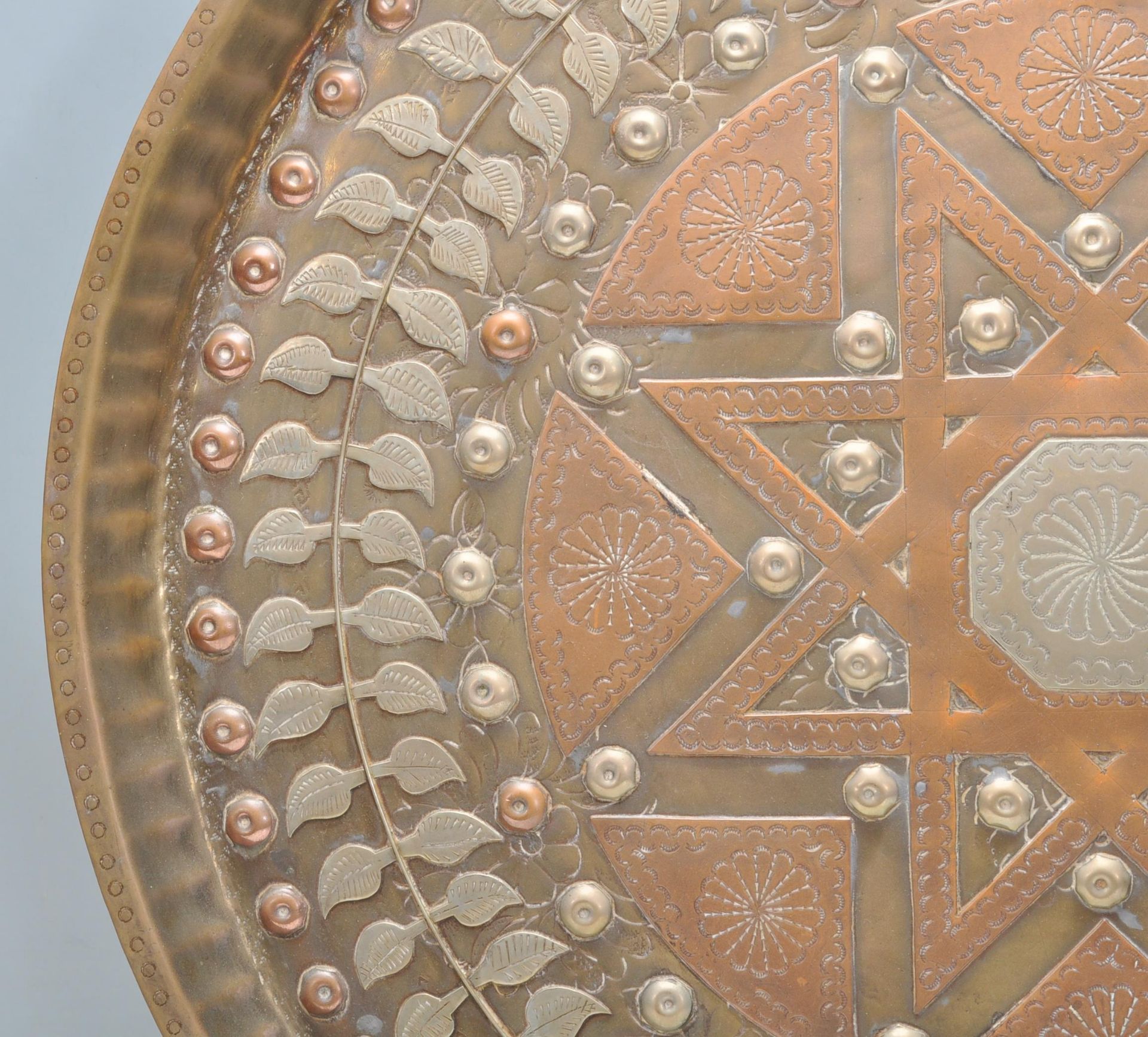 A 20th Century Middle Eastern brass and copper wall charger of circular form having inlaid white - Bild 5 aus 8