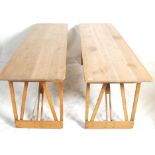 A pair of vintage retro 20th Century industrial wooden trestle tables having planked table tops with