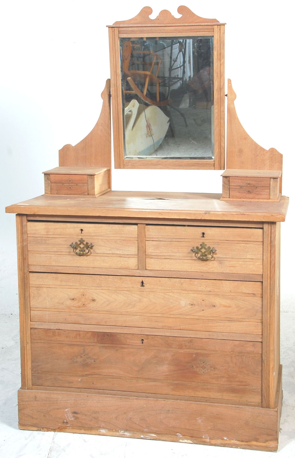 An early 20th Century Edwardian ash wood dressing table - chest of drawers having a central swing
