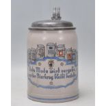 A vintage 20th Century German stoneware beer stein in the manner of Mettlack. The stein presented to