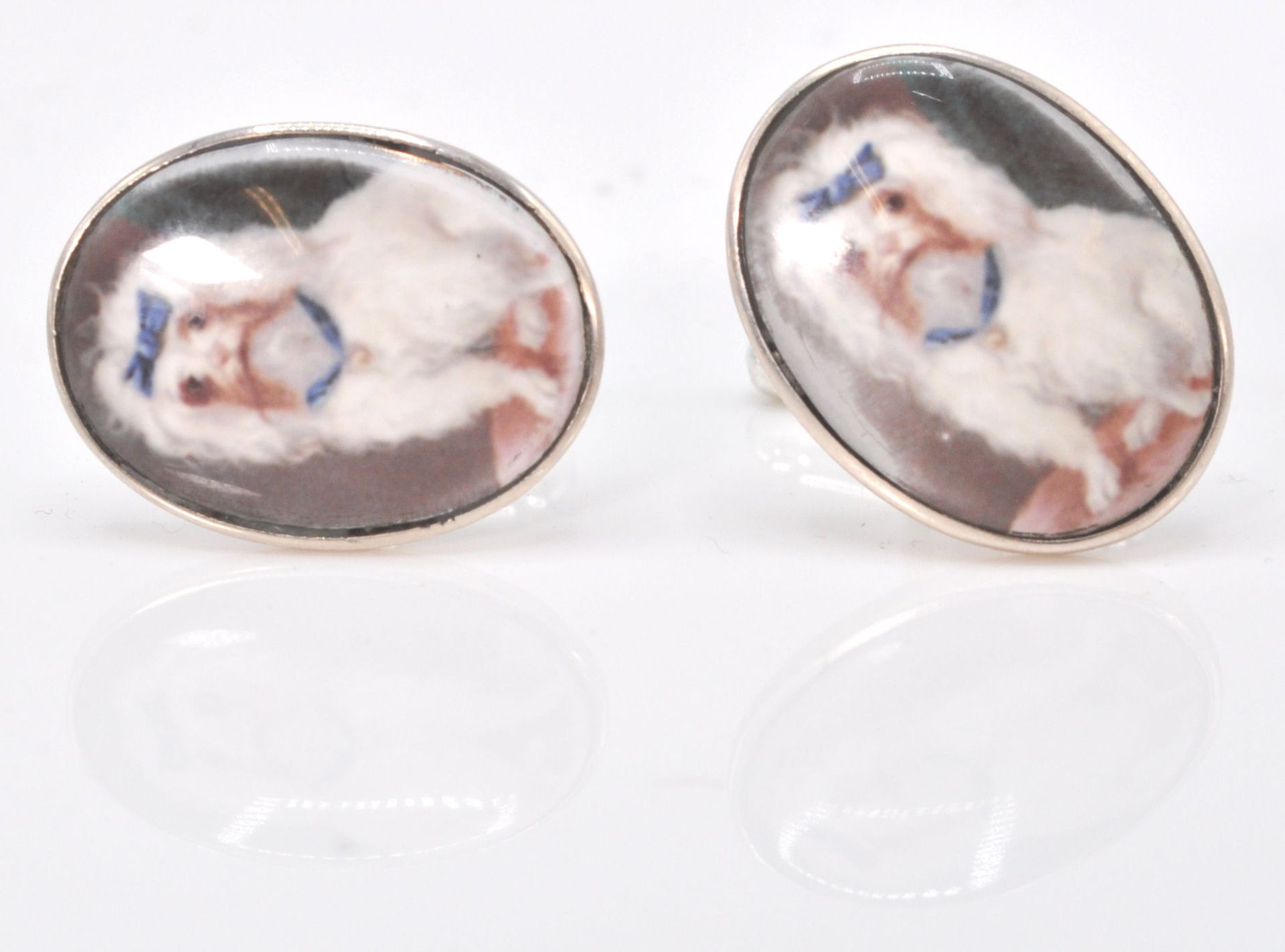 A charming pair of silver and enamel gentlemens cuff links decorated with a french poodle. Weighs