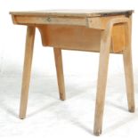 A mid century beech wood school desk raised on bentwood arched legs with hinged desk tops above