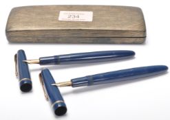 Two vintage parker writing ink / fountain pens having a blue body with gilt arrow clips, both with