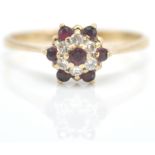 A 9ct gold ruby and diamond cluster ring. The ruby and diamond mixed cut stones in cluster setting