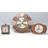 A group of three vintage retro clocks to include an Art Deco Ferranti bakelite cased electric clock,