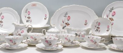 A large vintage German Mitterteich bone china dinner and tea service having moulded rims with