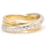 An 18 ct mixed gold diamond set crossover ring. Weighs 9.2g. Size 7.0 .04 points.