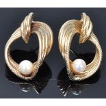 A pair of hallmarked 9ct gold vintage ladies stud earrings having knot design drops set with pearls.