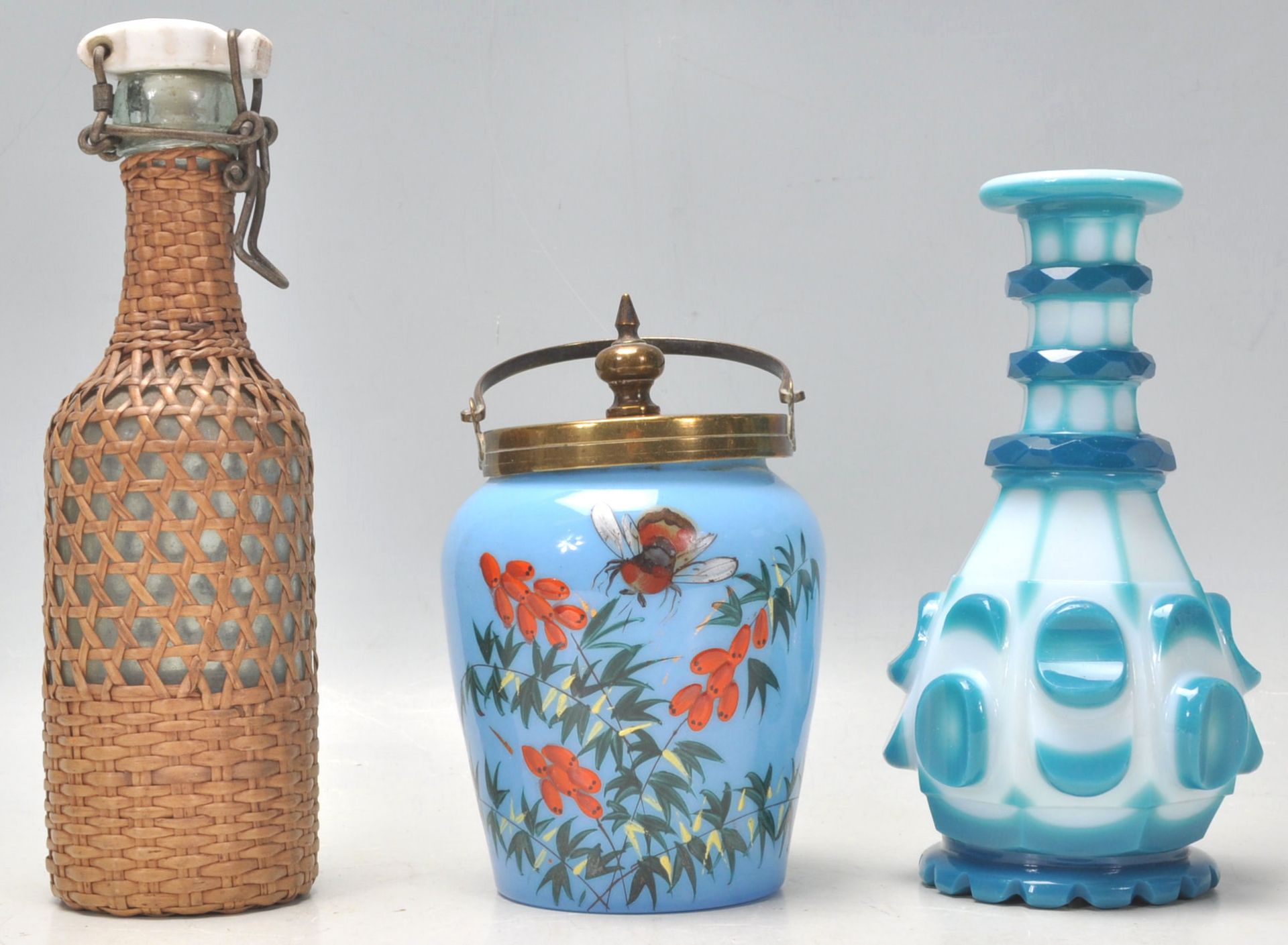 A collection of glassware to include a vintage Bohemian flash cut blue and white bottle vase, a