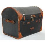 A late 19th Century Victorian domed top travelling trunk having an ebonised canvas body with brown