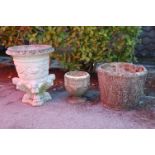 A group of three early 20th Century reconstituted stone garden planters to include a round planter