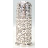 An antique Victorian hallmarked sterling silver repousse sugar shaker of cylindrical form
