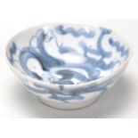 An 18th Century Japanese oriental blue and white footed bowl decorated with hand painted dragon