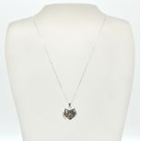 A 9ct white gold heart pendant locket and back chain. The fine linked necklace chain with c-clasp.