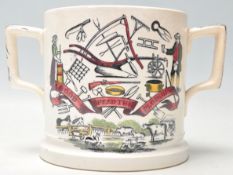 A 19th Century Victorian 'God Speed the Plough' loving cup having shaped twin handles and a transfer