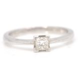 An 18ct white gold princess cut diamond with a four prong setting. Weighs 3.5g Size 5.L.