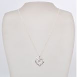 A 14 ct white gold diamond set heart shaped necklace with a cable chain and lobster clasp . Weighs