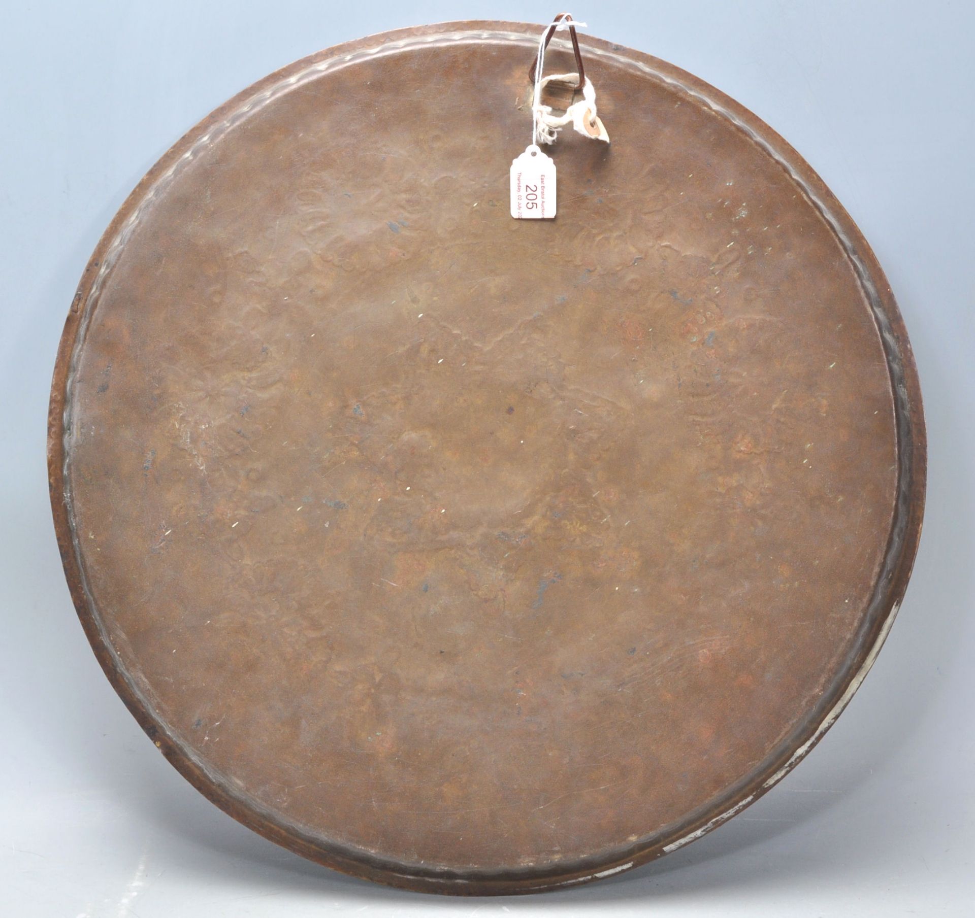 A 20th Century Middle Eastern brass and copper wall charger of circular form having inlaid white - Bild 7 aus 8