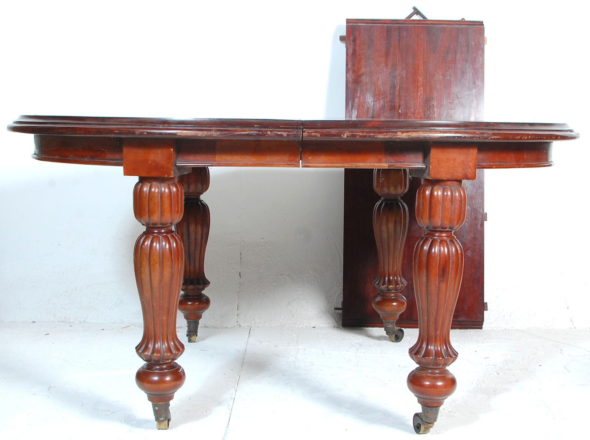 A good Victorian revival mahogany extending dining table in the William IV manner. Raised on