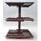 An antique style mahogany desktop revolving bookcase of small proportions with segregated shelves on